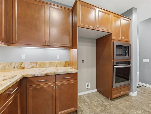 a kitchen with stainless steel appliances granite countertop a refrigerator and a stove