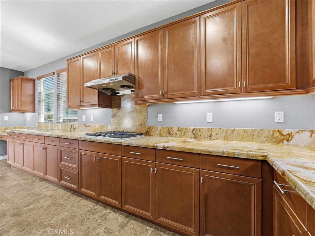 2947 Gilbert Avenue Corona, CA 92881 - Photo 16 of 60 a kitchen with granite countertop stainless steel appliances wooden cabinets and a sink