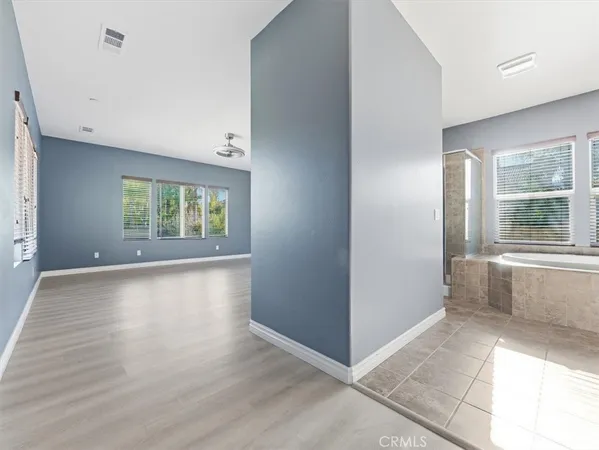 a spacious bathroom with a sink and a mirror