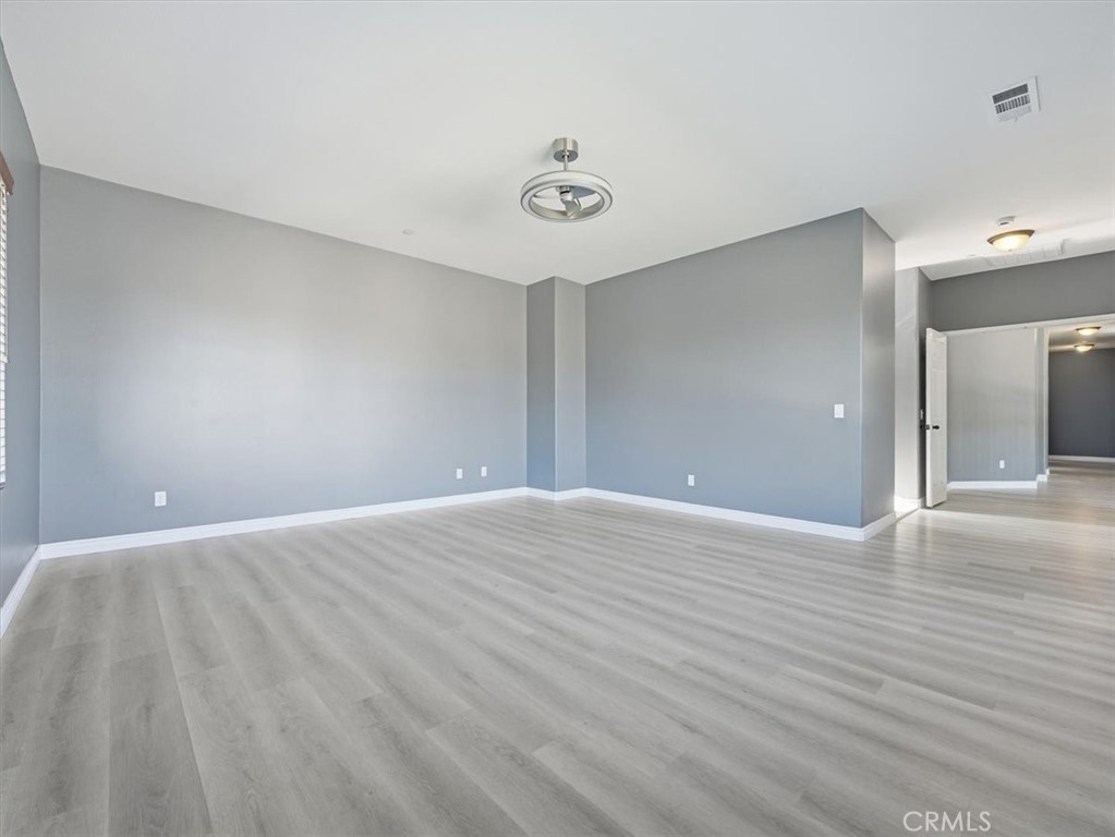 2947 Gilbert Avenue Corona, CA 92881 - Photo 26 of 60 a view of an empty room with wooden floor