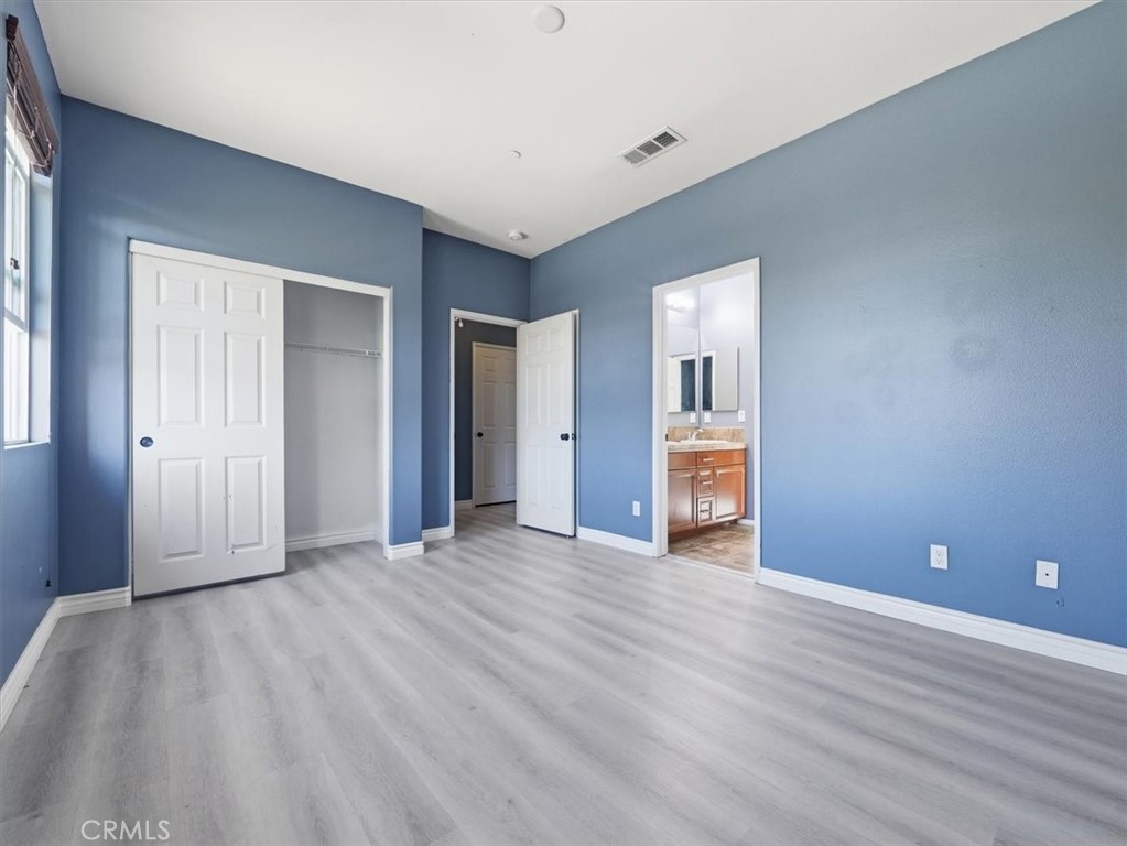 2947 Gilbert Avenue Corona, CA 92881 - Photo 31 of 60 a view of an empty room with wooden floor and a window