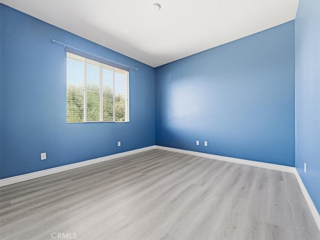 2947 Gilbert Avenue Corona, CA 92881 - Photo 34 of 60 a view of an empty room with wooden floor and a window