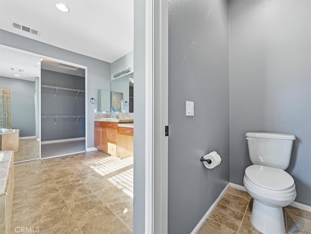 2947 Gilbert Avenue Corona, CA 92881 - Photo 47 of 60 a bathroom with a toilet and a sink