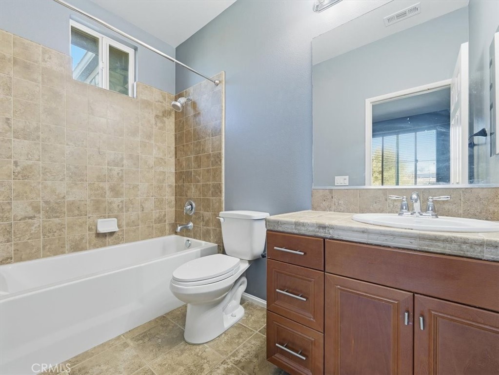2947 Gilbert Avenue Corona, CA 92881 - Photo 52 of 60 a bathroom with a granite countertop sink toilet and shower