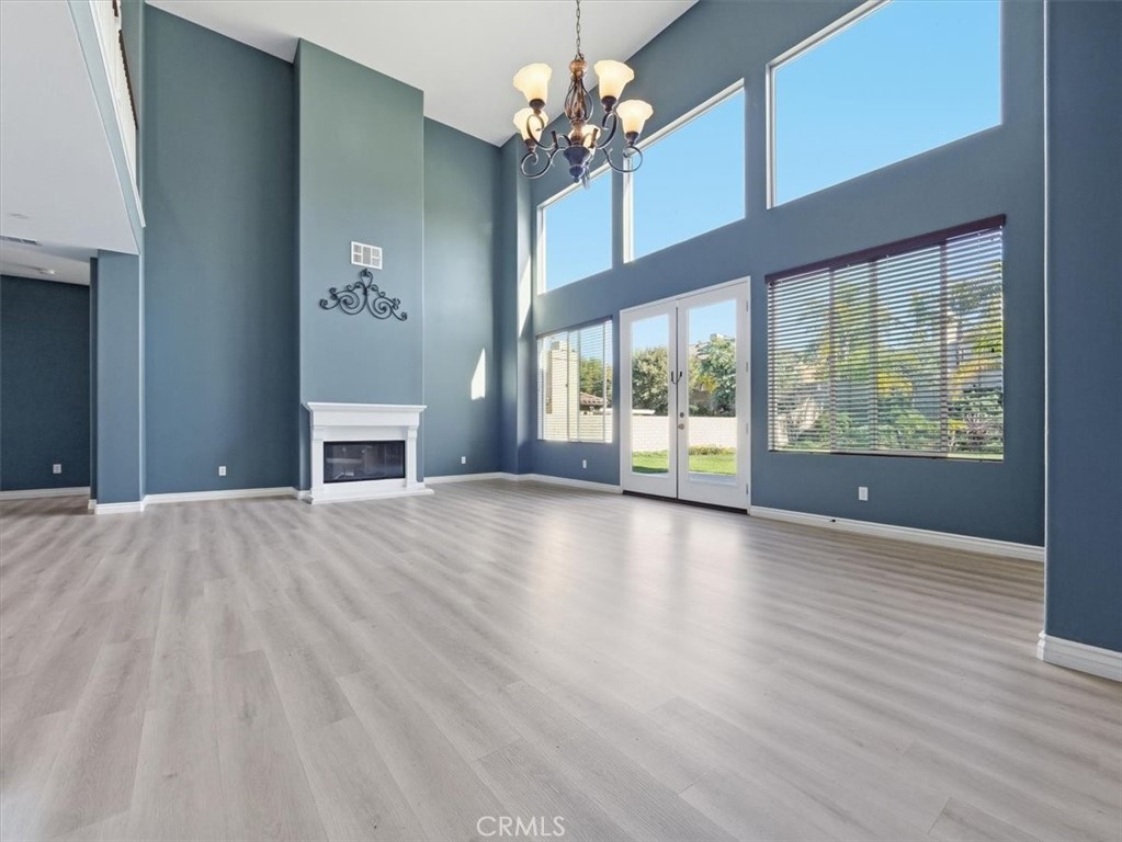 2947 Gilbert Avenue Corona, CA 92881 - Photo 6 of 60 a view of an empty room with a window and wooden floor