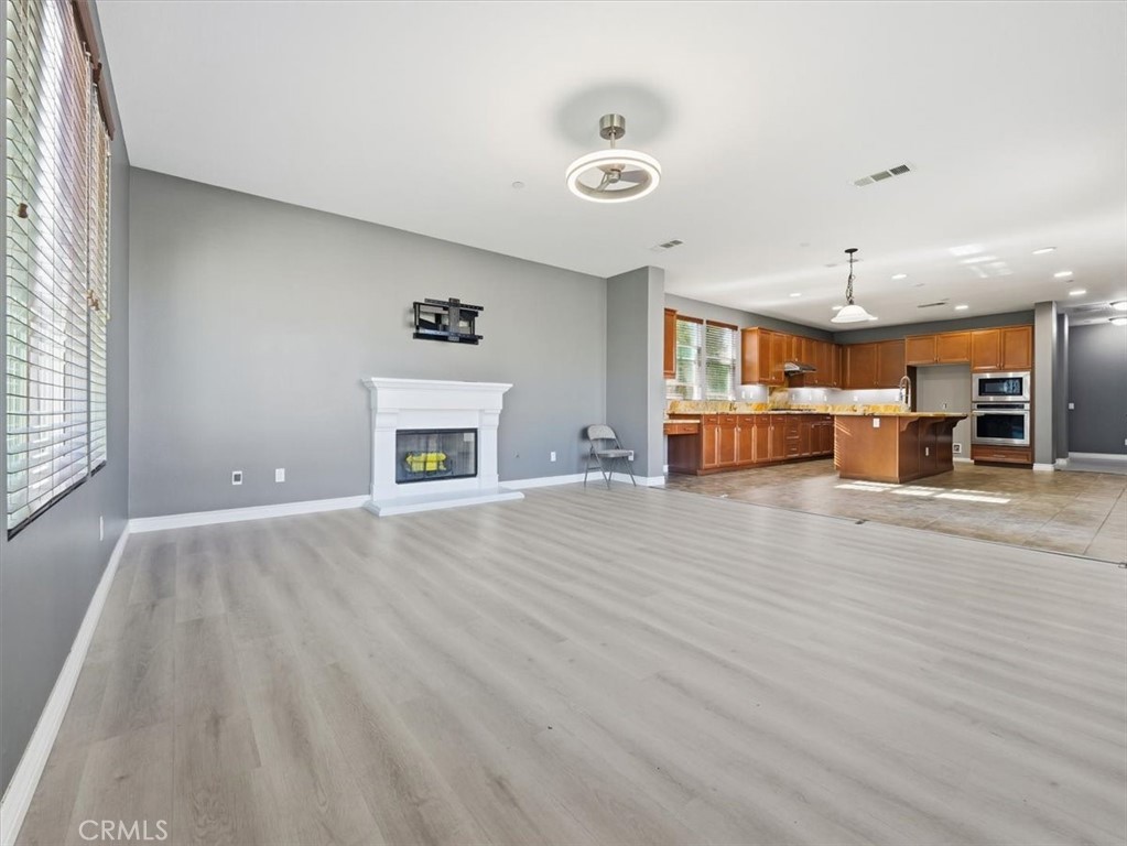 2947 Gilbert Avenue Corona, CA 92881 - Photo 10 of 60 an empty room with wooden floor and windows