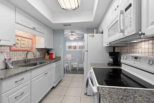 a bathroom with a toilet sink vanity tub and shower