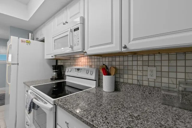 a bedroom with two beds and painting on the wall