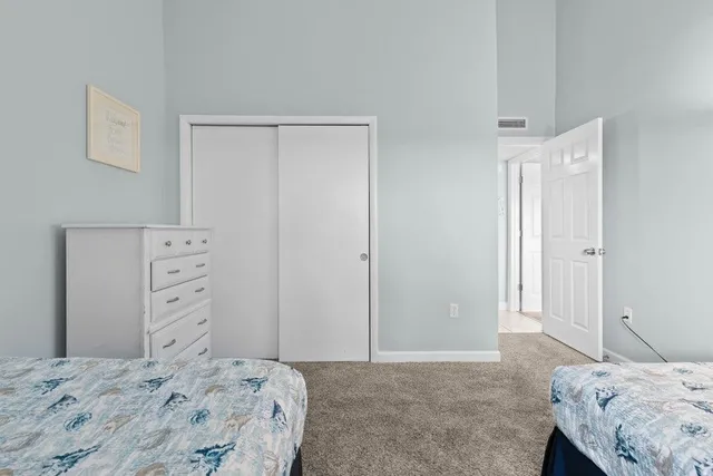 a bedroom with a large bed and a large window