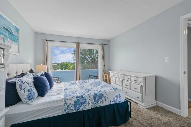 a bedroom with a large bed and a lamp on table