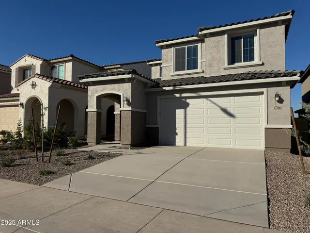 a view of a white house with large windows