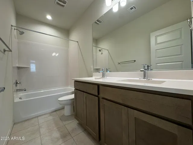 an empty room with a projector and fan