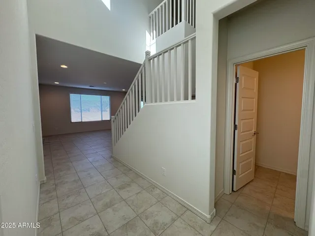 a view of a hallway with entryway and stairs
