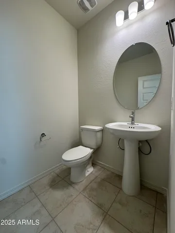 a bathroom with a sink toilet and mirror
