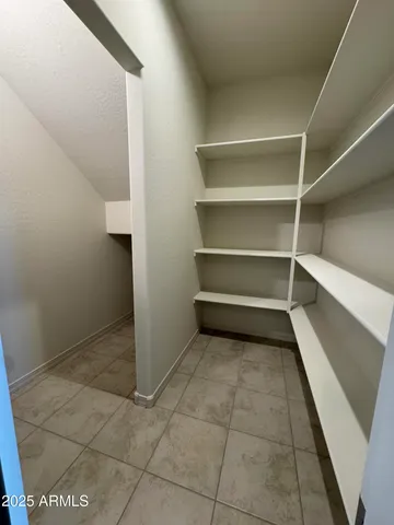 a view of an empty room with white walls