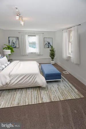 a bedroom with a large bed and a potted plant