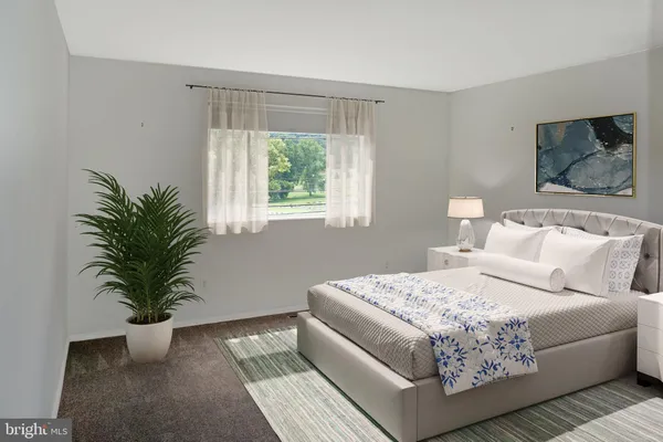 a bedroom with a bed and a lamp