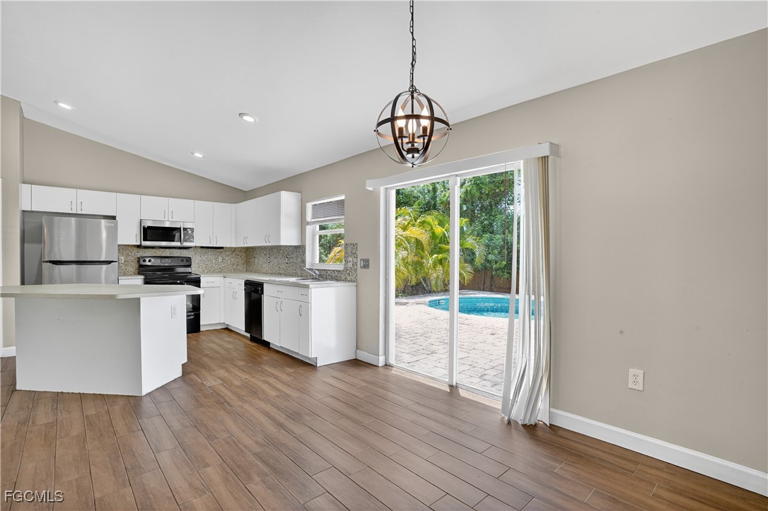 8811 Buckingham Road Fort Myers, FL 33905 - Photo 13 of 30 a view of kitchen with granite countertop stainless steel appliances cabinets a dining table and chairs