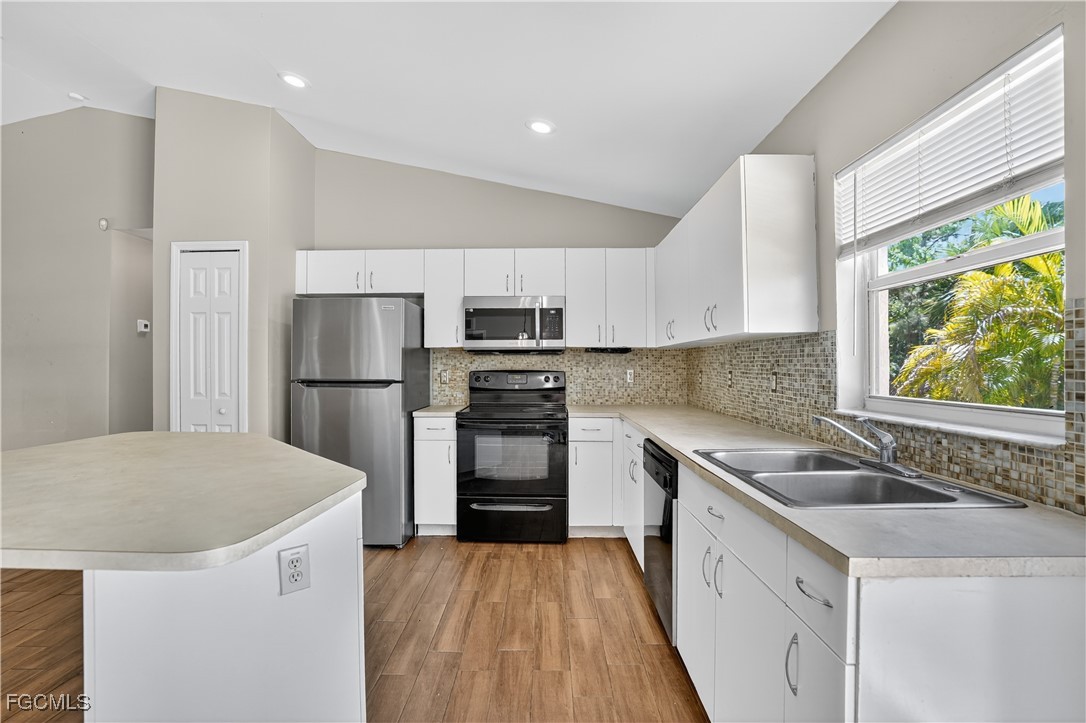8811 Buckingham Road Fort Myers, FL 33905 - Photo 15 of 30 a kitchen with a sink a stove a refrigerator and a sink