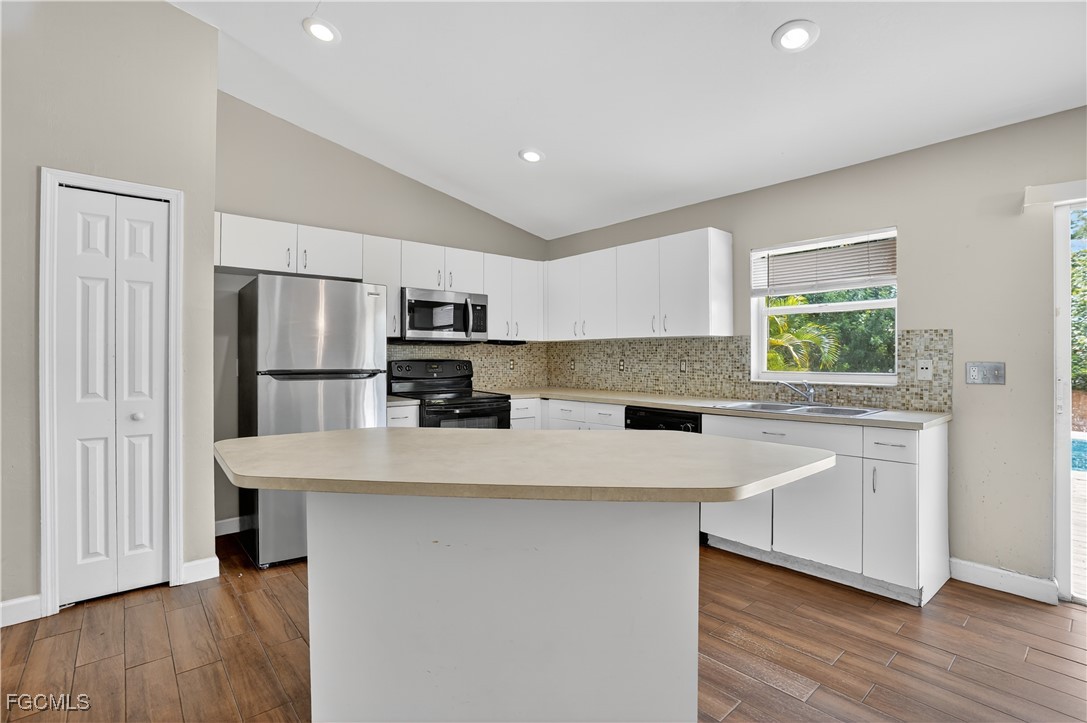 8811 Buckingham Road Fort Myers, FL 33905 - Photo 16 of 30 a kitchen with stainless steel appliances a refrigerator sink and microwave