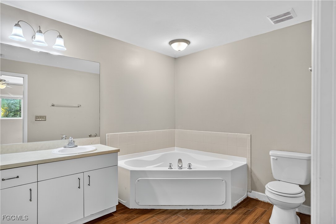 8811 Buckingham Road Fort Myers, FL 33905 - Photo 18 of 30 a bathroom with a bathtub and sink