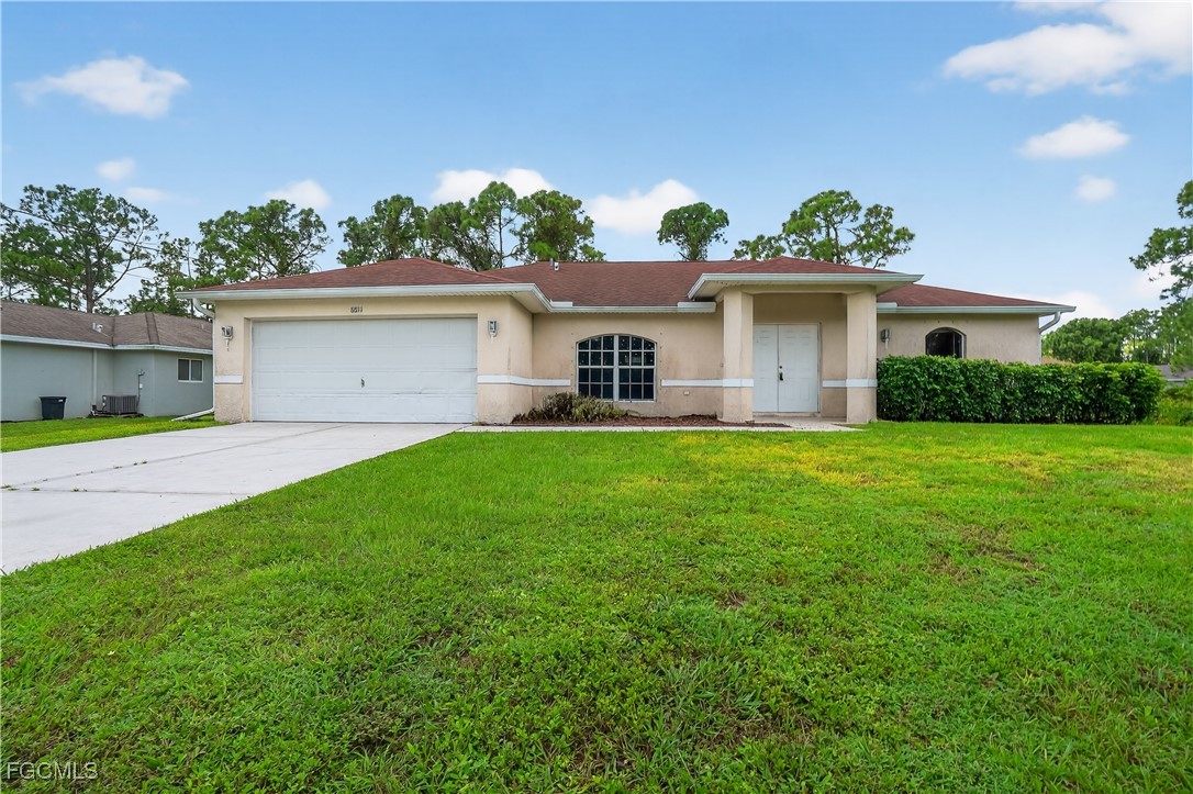 8811 Buckingham Road Fort Myers, FL 33905 - Photo 2 of 30 a front view of house with yard and green space
