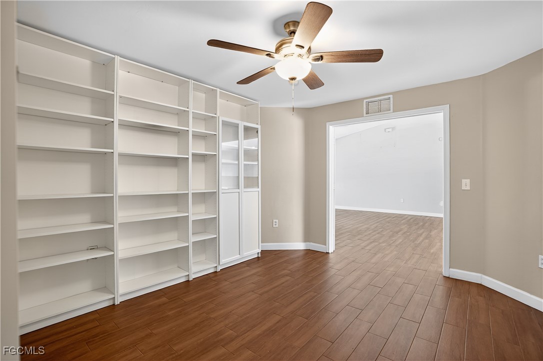 8811 Buckingham Road Fort Myers, FL 33905 - Photo 21 of 30 a view of an empty room with a window and wooden floor