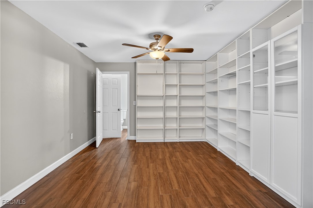 8811 Buckingham Road Fort Myers, FL 33905 - Photo 22 of 30 a view of empty room with wooden floor and fan
