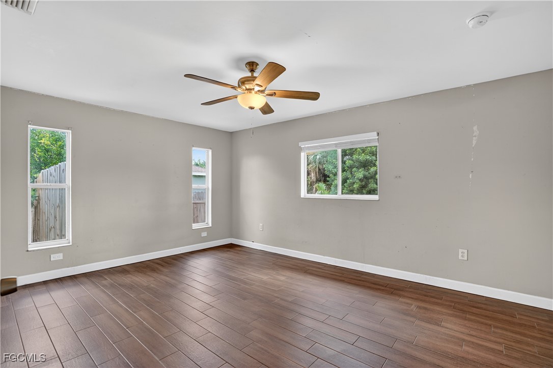 8811 Buckingham Road Fort Myers, FL 33905 - Photo 26 of 30 a view of an empty room with a window and wooden floor