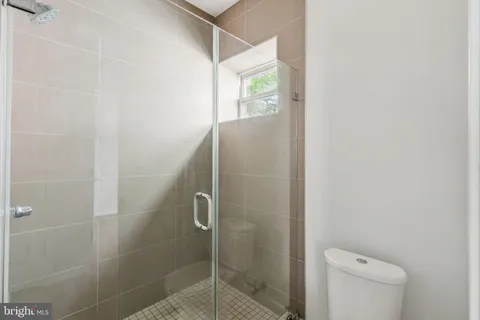 a bathroom with a shower and toilet