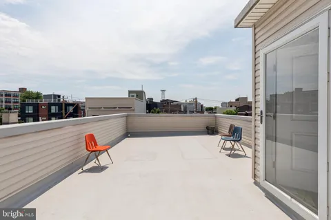 a terrace with outdoor seating and city view