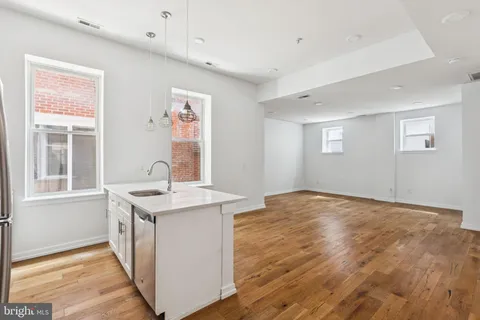 a view of a kitchen with a sink and a window