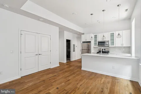 a view of kitchen with sink and refrigerator