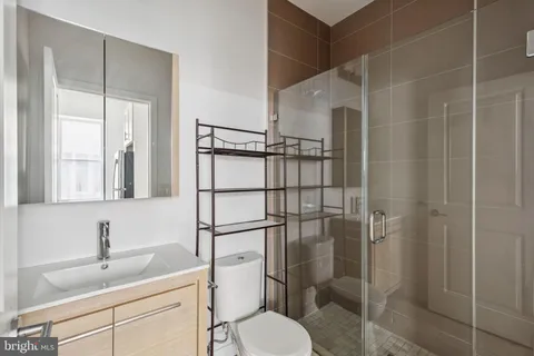 a bathroom with a toilet sink shower and mirror