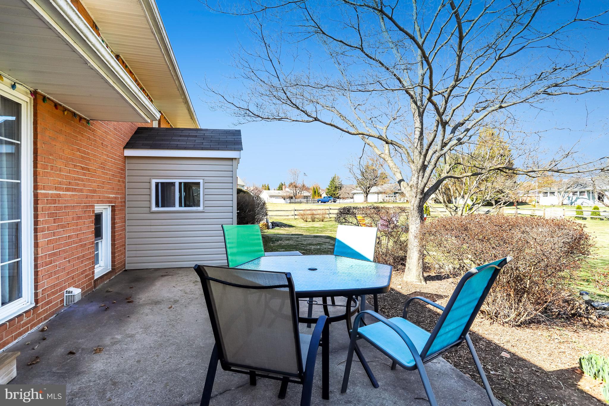 7951 Yellow Springs Road Frederick, MD 21702 - Photo 14 of 22 a view of a patio with table and chairs and wooden fence