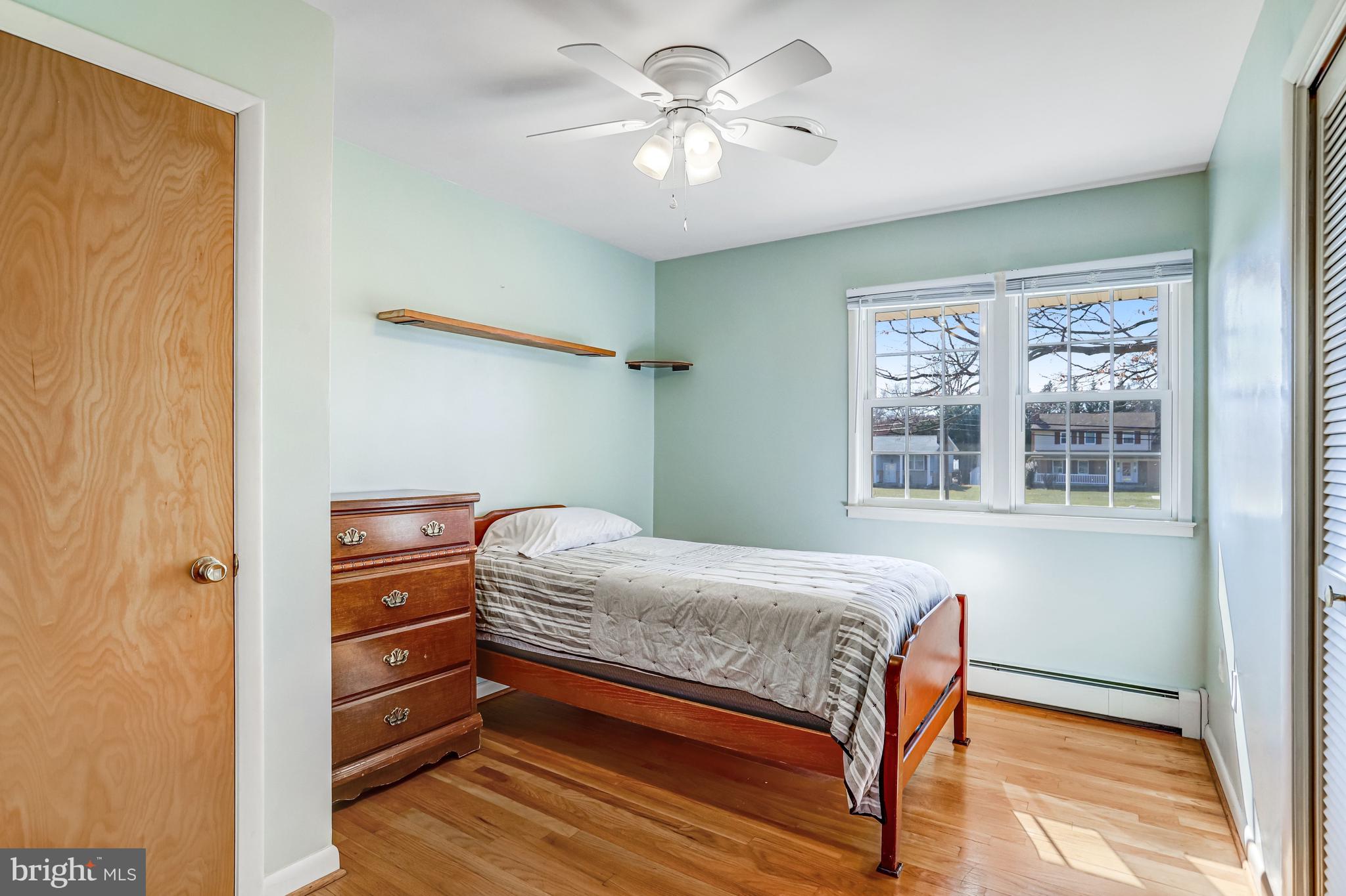 7951 Yellow Springs Road Frederick, MD 21702 - Photo 7 of 22 a bedroom with a bed and a chandelier fan