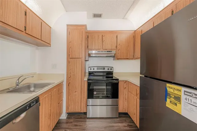 an aerial view of a house with garden space and street view