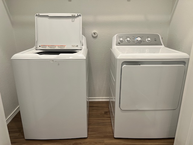 379 Geode Glen Maxwell, TX 78656 - Photo 10 of 12 Washroom featuring dark wood-style floors, baseboards, and separate washer and dryer