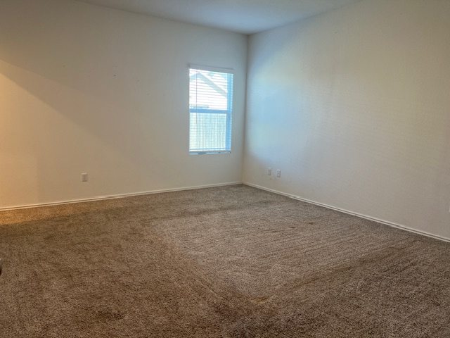 379 Geode Glen Maxwell, TX 78656 - Photo 6 of 12 Carpeted spare room with baseboards
