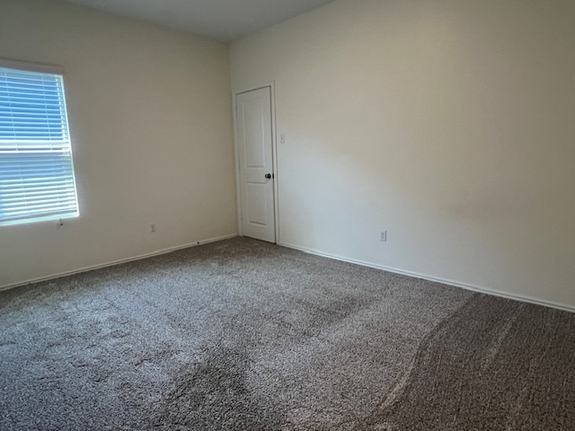 379 Geode Glen Maxwell, TX 78656 - Photo 9 of 12 Carpeted spare room featuring baseboards