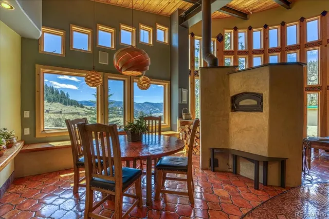 a view of a dining room with a table and chairs