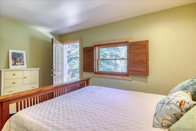 a room with pool table and windows