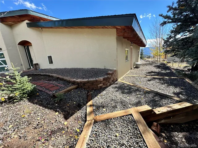 a view of a backyard with sitting area
