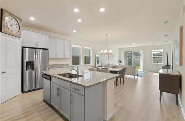 a kitchen with counter top space a sink stainless steel appliances and cabinets