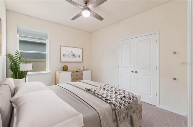 a bedroom with a large bed and a chandelier