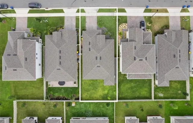 a aerial view of a house with a yard