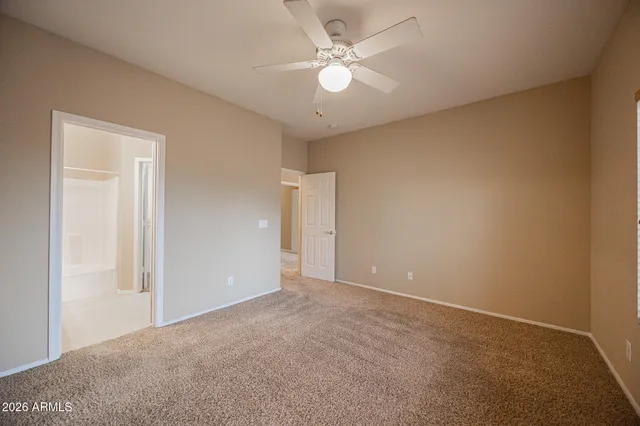 a view of an empty room with a ceiling fan