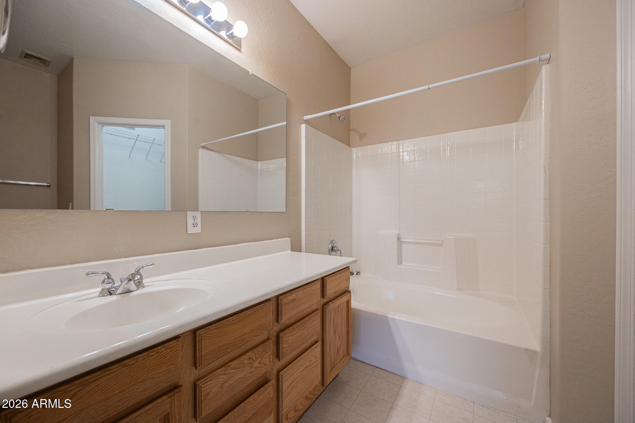 6426 South Nash Way Chandler, AZ 85249 - Photo 13 of 23 a bathroom with a sink vanity granite tub shower and a mirror