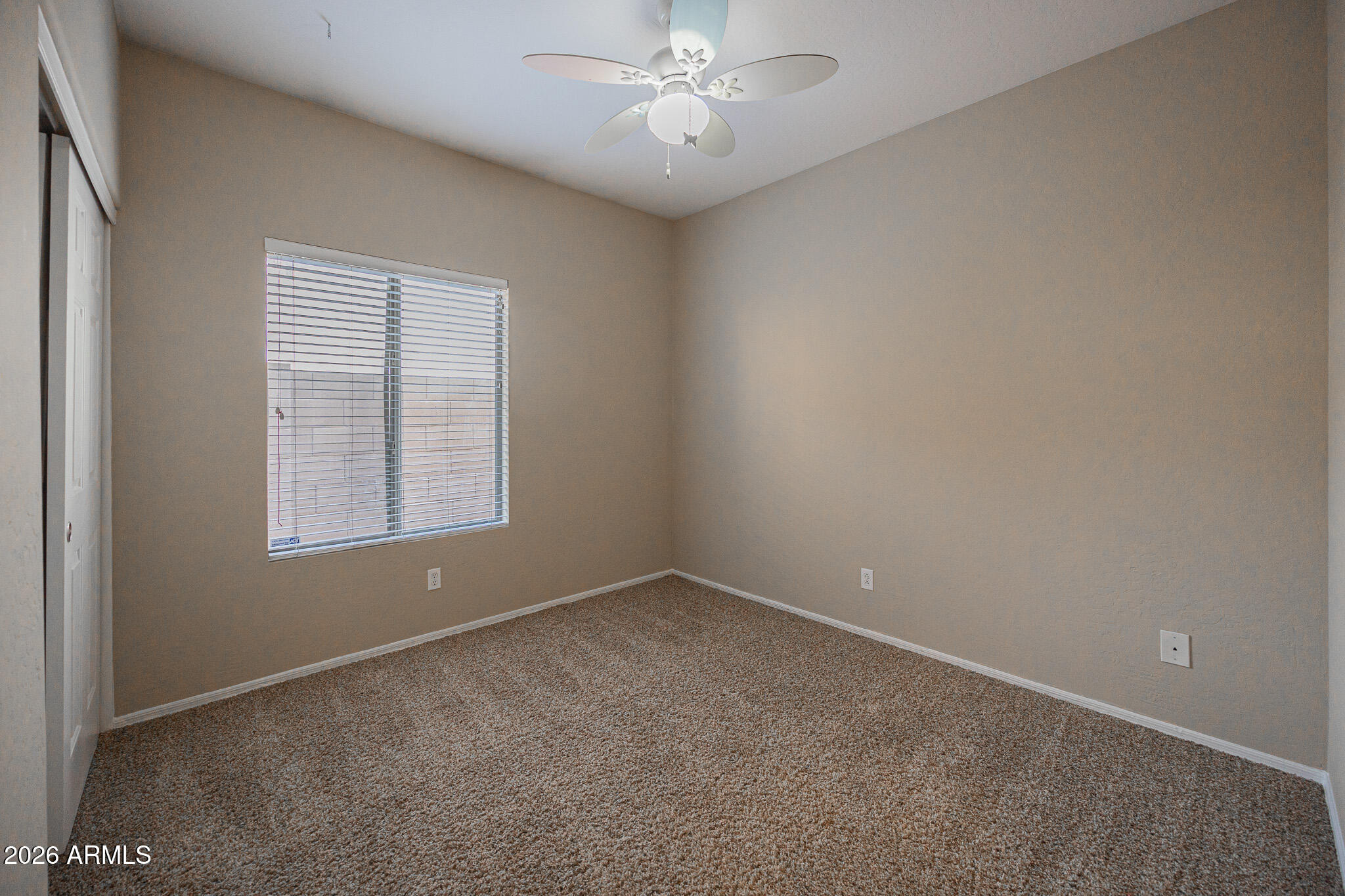6426 South Nash Way Chandler, AZ 85249 - Photo 17 of 23 an empty room with a window and a fan