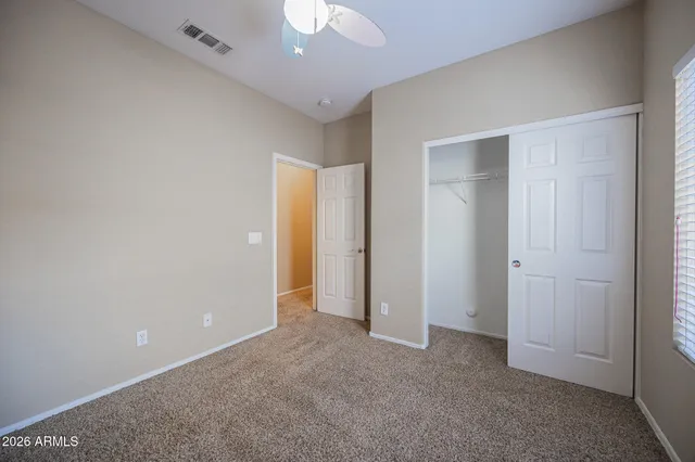 an empty room with closet area
